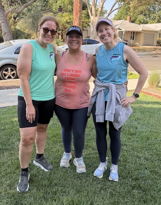 Coach Sabrina with two athletes after a run